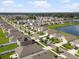A vibrant neighborhood view with lush landscaping and a tranquil pond at 11617 Miracle Mile Dr, Riverview, FL 33578