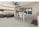 Covered outdoor space with comfortable seating, outdoor TV, and views of the backyard at 11617 Miracle Mile Dr, Riverview, FL 33578