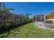 The backyard showcases a lush lawn, a private fence, and mature trees, offering a serene outdoor space at 12406 Bristol Commons Cir, Tampa, FL 33626