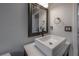 Modern bathroom with a sleek sink, decorative mirror, and stylish fixtures at 12406 Bristol Commons Cir, Tampa, FL 33626