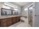 Bathroom features dual sinks with granite countertops, a tub, and a glass enclosed shower at 12406 Bristol Commons Cir, Tampa, FL 33626