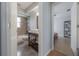 Bathroom features a modern vanity, tiled shower, and views into an adjacent light-filled bedroom at 12406 Bristol Commons Cir, Tampa, FL 33626
