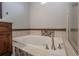 Bathtub area features a tile design and sleek hardware, perfect for relaxation and comfort at 12406 Bristol Commons Cir, Tampa, FL 33626