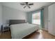 Bedroom featuring a neutral color scheme, wood-look floors, and window with blinds at 12406 Bristol Commons Cir, Tampa, FL 33626