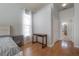 Comfortable bedroom featuring hardwood floors, a side table, and a modern wood desk at 12406 Bristol Commons Cir, Tampa, FL 33626
