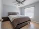 A cozy bedroom with a ceiling fan, a window, and neutral decor, providing a relaxing space at 12406 Bristol Commons Cir, Tampa, FL 33626