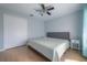 Bright bedroom with a large bed, wood-look floors, and a ceiling fan at 12406 Bristol Commons Cir, Tampa, FL 33626