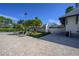 Well-manicured community amenities area with seating, lush landscaping, and a charming building at 12406 Bristol Commons Cir, Tampa, FL 33626