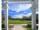 Lush community green space framed by a white pergola, offering a picturesque setting for relaxation at 12406 Bristol Commons Cir, Tampa, FL 33626