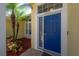 Bright yellow home exterior featuring a stylish navy blue front door at 12406 Bristol Commons Cir, Tampa, FL 33626
