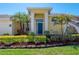 Close-up of the front door with manicured garden and stone border at 12406 Bristol Commons Cir, Tampa, FL 33626