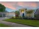 Charming single-story home with a well-manicured lawn, vibrant landscaping, and a two-car garage at 12406 Bristol Commons Cir, Tampa, FL 33626