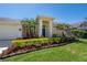 Charming home with vibrant landscaping, lush lawn, and a welcoming entrance at 12406 Bristol Commons Cir, Tampa, FL 33626