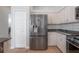 Updated kitchen with stainless steel refrigerator, white cabinets, and a subway tile backsplash at 12406 Bristol Commons Cir, Tampa, FL 33626