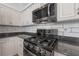 Close-up of the kitchen featuring stainless steel appliances, granite countertops, and white subway tile backsplash at 12406 Bristol Commons Cir, Tampa, FL 33626