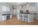 Modern kitchen featuring white cabinetry, stainless steel appliances, and a breakfast bar with stylish pendant lighting at 12406 Bristol Commons Cir, Tampa, FL 33626