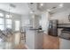 Open-concept kitchen with granite countertops, stainless steel appliances, and breakfast bar seating at 12406 Bristol Commons Cir, Tampa, FL 33626