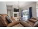 Cozy living room with fireplace, modern lighting, and sliding doors to pool at 12406 Bristol Commons Cir, Tampa, FL 33626