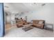 Spacious living room with tile flooring, modern lighting, and open layout at 12406 Bristol Commons Cir, Tampa, FL 33626