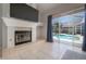 Bright living room with a fireplace and a large glass sliding door overlooking the screened-in pool at 12406 Bristol Commons Cir, Tampa, FL 33626