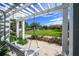 Relax on this white swing under a pergola, with views of the community green space at 12406 Bristol Commons Cir, Tampa, FL 33626
