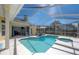Outdoor swimming pool with screened enclosure, offering a tranquil retreat with lounge chairs and ample sunlight at 12406 Bristol Commons Cir, Tampa, FL 33626