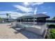 Relaxing poolside area with lounge chairs, covered seating, and views of the pool and neighboring buildings at 12406 Bristol Commons Cir, Tampa, FL 33626