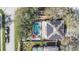 This aerial view showcases a home with a screened-in pool, solar panels, and a well-maintained outdoor space at 12705 Longcrest Dr, Riverview, FL 33579