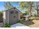 This backyard features a storage shed and BBQ grill at 12705 Longcrest Dr, Riverview, FL 33579