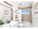 Bathroom features updated fixtures, neutral paint, modern lighting, and a shower over tub, offering relaxation at 12705 Longcrest Dr, Riverview, FL 33579