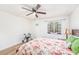 Inviting bedroom with wood-look floors, floral bedding, and plenty of natural light at 12705 Longcrest Dr, Riverview, FL 33579