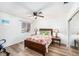 Inviting bedroom with wood-look floors, floral bedding, and plenty of natural light at 12705 Longcrest Dr, Riverview, FL 33579