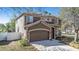 This is a two-story home showcasing its exterior, a well-manicured lawn, and a two-car garage at 12705 Longcrest Dr, Riverview, FL 33579