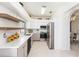 Bright kitchen with stainless steel appliances, sleek white cabinets, and quartz countertops at 12705 Longcrest Dr, Riverview, FL 33579