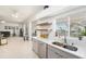 Well-lit kitchen with stainless steel appliances, sleek countertops, and an open design overlooking the backyard at 12705 Longcrest Dr, Riverview, FL 33579