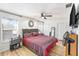 Comfortable bedroom featuring wood-look flooring, ceiling fan, and ample natural light at 12705 Longcrest Dr, Riverview, FL 33579