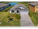 Desirable home on a well-manicured lot with a lake view, paved driveway, and two-car garage at 12730 Oak Hill Way, Parrish, FL 34219