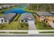 Beautifully landscaped home featuring mature landscaping, an inviting entry, a paved driveway, and a two-car garage at 12730 Oak Hill Way, Parrish, FL 34219
