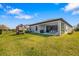Spacious backyard featuring a well-maintained lawn, covered patio, play set, and fenced perimeter at 12730 Oak Hill Way, Parrish, FL 34219