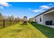 Spacious backyard featuring a well-maintained lawn, play set, and fenced perimeter with a beautiful view at 12730 Oak Hill Way, Parrish, FL 34219