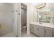 Well-lit bathroom with a glass shower and vanity with double mirrors at 12730 Oak Hill Way, Parrish, FL 34219