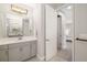 Bathroom with large mirror and open doorway to an ensuite bedroom at 12730 Oak Hill Way, Parrish, FL 34219