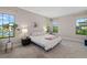 Serene bedroom with calming decor, plush carpet, and natural light offers a tranquil escape at 12730 Oak Hill Way, Parrish, FL 34219