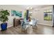 Dining area with modern lighting, bright light, floral chairs, and wood-look floors at 12730 Oak Hill Way, Parrish, FL 34219