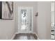 Bright foyer with stylish front door with sidelights, wood flooring, and neutral wall colors at 12730 Oak Hill Way, Parrish, FL 34219