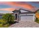 Charming single-Gathering home with well-manicured lawn and a two-car garage and beautiful stone accents at 12730 Oak Hill Way, Parrish, FL 34219