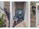 Inviting front porch featuring stone accents, a seating area, and stylish exterior lighting fixtures at 12730 Oak Hill Way, Parrish, FL 34219
