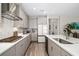 Gourmet kitchen with stainless steel appliances, gas cooktop, island with seating, and quartz countertops at 12730 Oak Hill Way, Parrish, FL 34219
