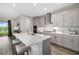Bright kitchen features quartz countertops, stainless appliances, an island with seating and gray cabinets at 12730 Oak Hill Way, Parrish, FL 34219