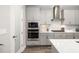 Modern kitchen with stainless steel appliances and stylish gray cabinets at 12730 Oak Hill Way, Parrish, FL 34219